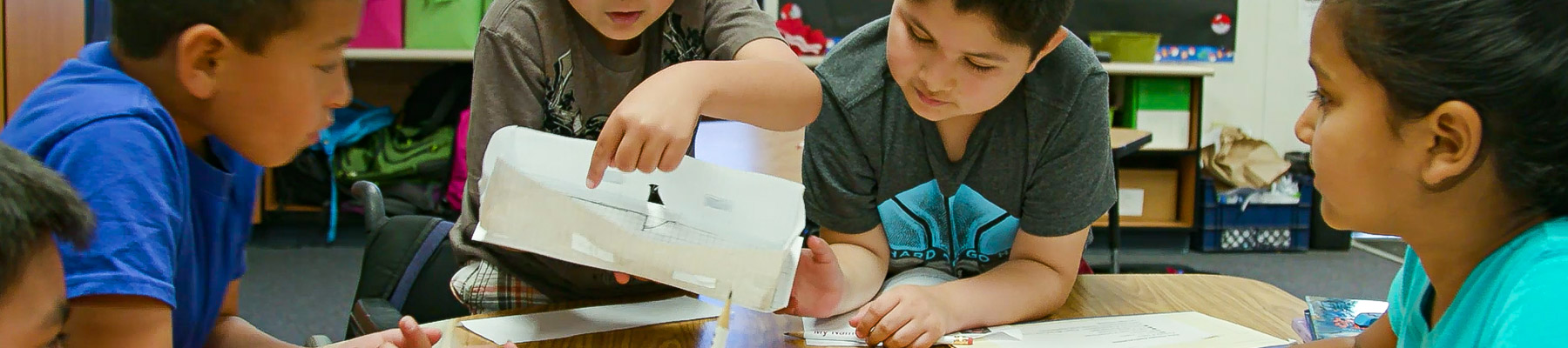 Children working together around table