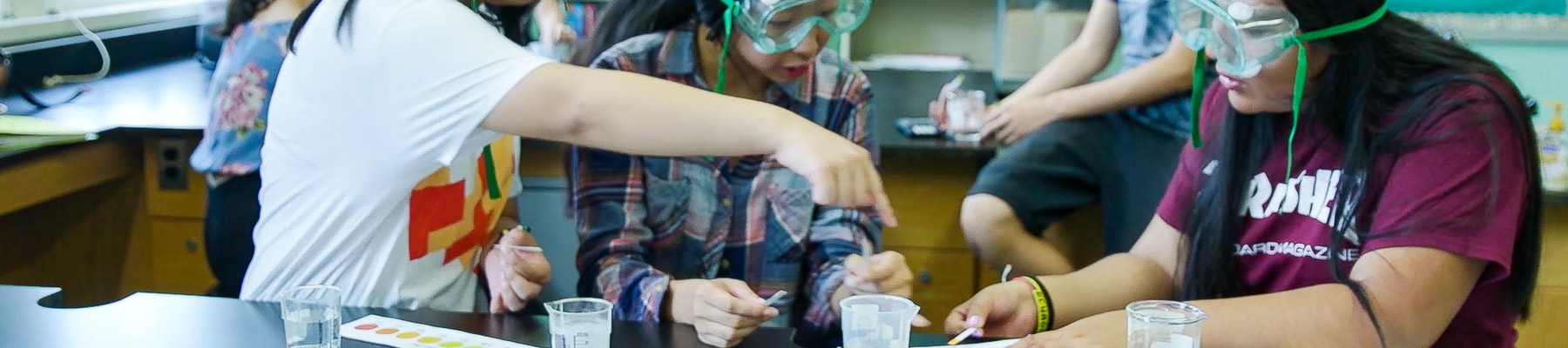 Children wearing goggles and working together on project